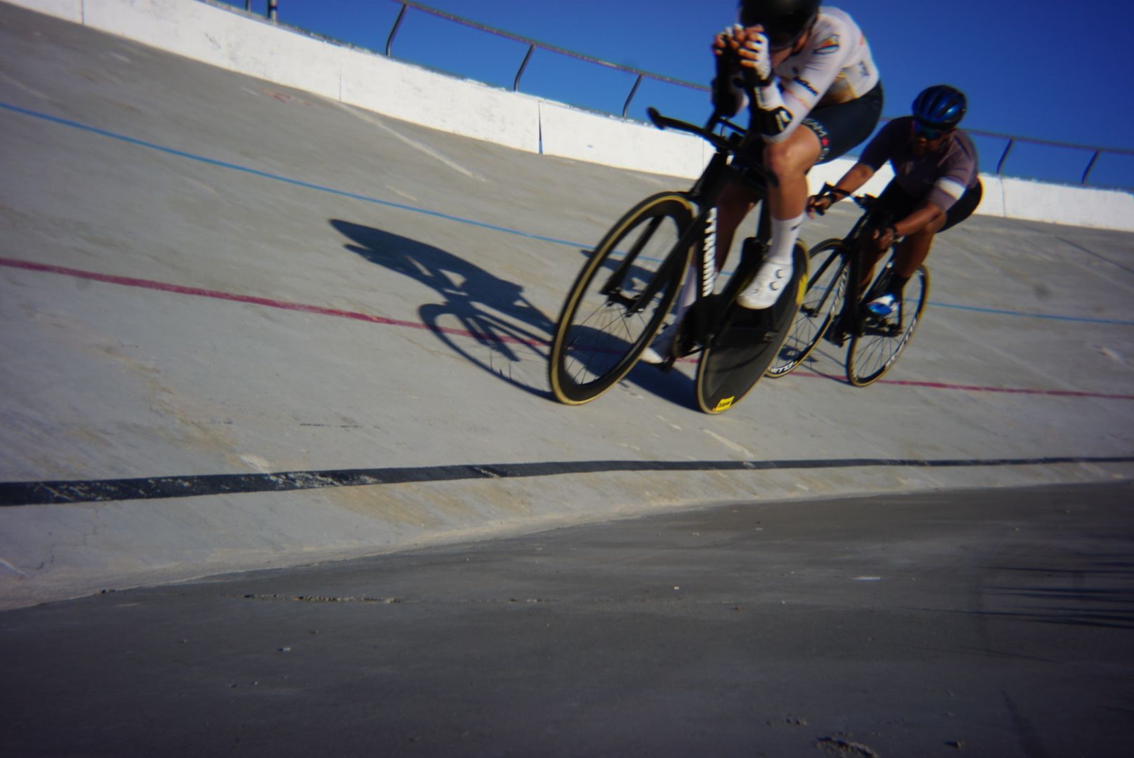 Two riders, long shadows.