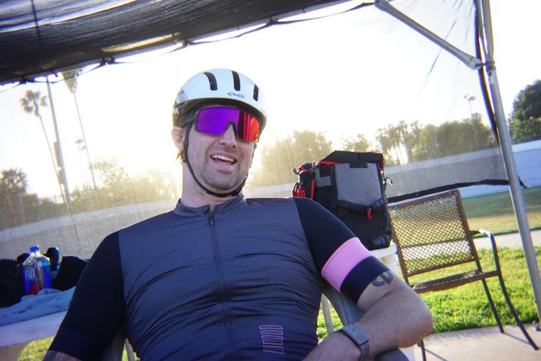 Under the canopy, helmet on, glasses up.
