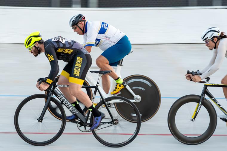 Panning shot: three riders, one on a disc.